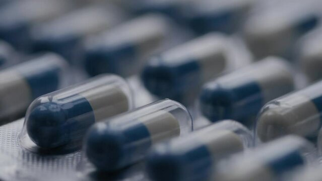 blue-white capsules rotate in a circle