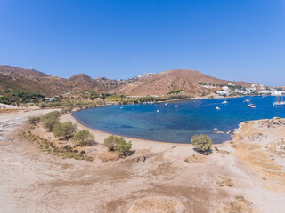 Fototapeta premium Aerial view of sailing boats in the natural harbor at Aegean Sea of Patmos island, Greece