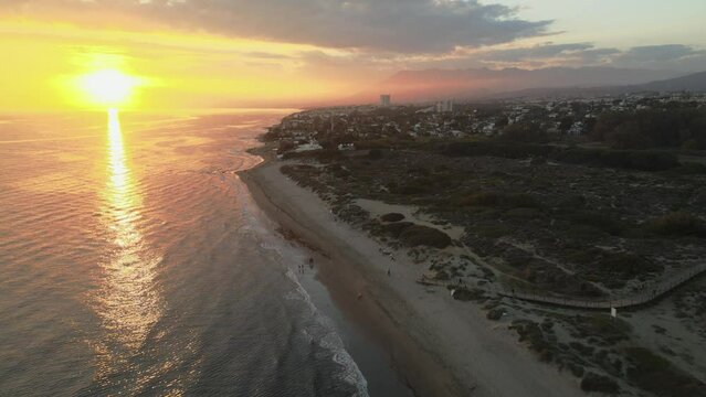 Orange sunset of the ocean beach. Sunset on Marbella, on Mediterranean Sea. Sunset on the beach of Costa del Sol