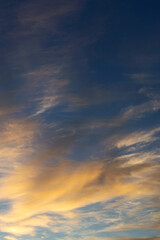 blue sky with golden clouds beautifully illuminated by the sun as a natural background