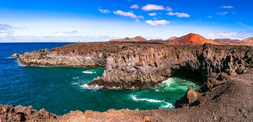 Tuinposter Volcanic Lanzarote island scenery. View of  Los Hervideros caves and cliffs and Red mountain . popular tourist destination Canary islands © Freesurf