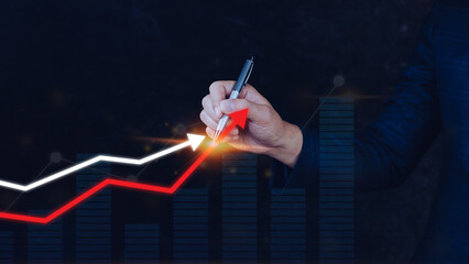 Businessman hand drawing touching rising red and white arrow, representing business growth, financial and investment success concepts