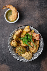 Japanese prawns and vegetable tempura on dark background