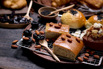 Sweet pastries, fresh baked fruit cake with sourdough and Danish pastry, puff pastry, breads and many desserts on wood table, delicious homemade bakery concept