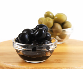 Black olives in a glass container. Shallow depth of field