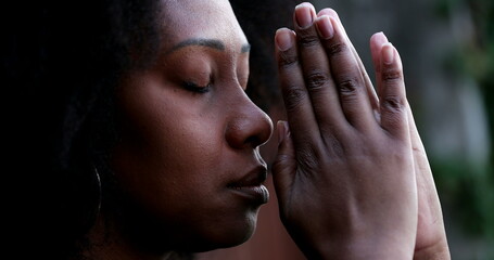 African woman praying to God asking for spiritual guidance
