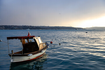 fishing boat at sunrise in the bosphorus , nautical concept
