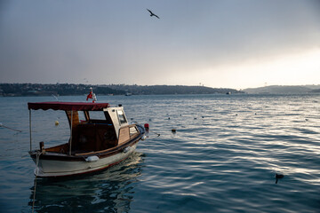 Obraz premium fishing boat at sunrise in the bosphorus , nautical concept