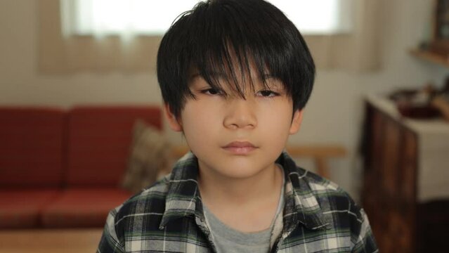 Asian teenage boy opens his eyes and stars the camera. Loneliness, Sadness, Emotionless. Dolly in.