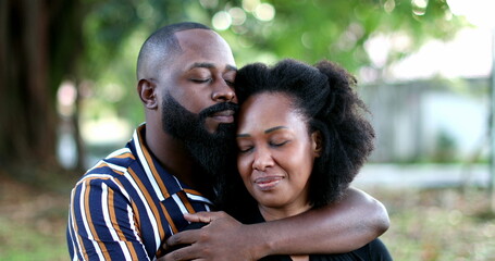 African couple love and affection, girlfriend and boyfriend embrace together at park