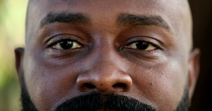 African black man close-up eyes looking at camera, real people
