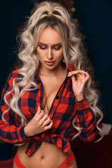 A bright blonde with long hair in a checkered top. Attractive cleavage and breasts