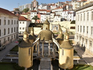 Cream colored towers of Jardim da Manga cloister symbolizing a central Garden of Eden from which four rivers or ponds radiate in the four cardinal directions, Coimbra, Portugal