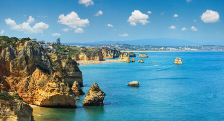 Ponta da Piedade (group of rock formations along coastline of Lagos town, Algarve, Portugal). People are unrecognizable.