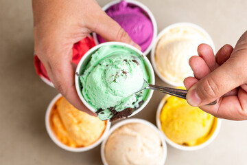 mãos segurando copinho de sorvete