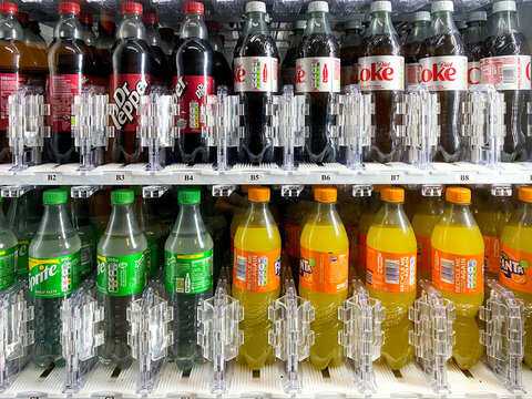 Bottles of carbonated drinks for sale in a vending machine