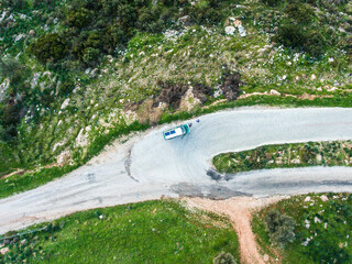 Aerial view of roof the van including solar panels and long surfboard.