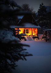 Wooden house in the winter night - 553558897