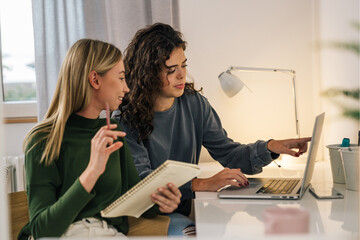 College friends study together in a dorm