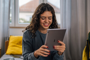 Fototapeta premium Front view of a brunette college student studying in a dorm room