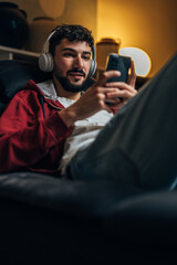 Young man uses his phone in the evening