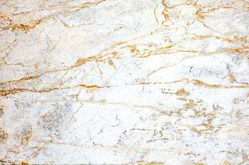 Marble light surface with numerous chaotically arranged orange veins