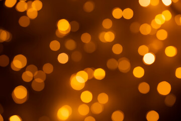 Abstract bokeh background - gold, orange, light blurred glitter lights - 