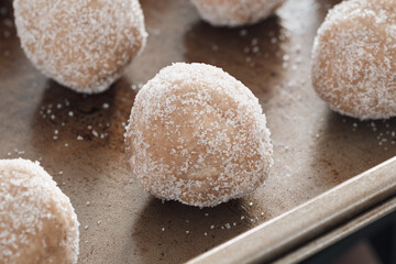 Ginger cookie dough balls on baking sheet