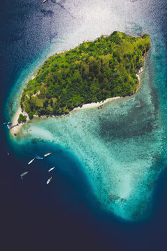 View from directly above of boats moored in the water off Batu Bolong Beach in Komodo National Park; Canggu, Bali, Indonesia