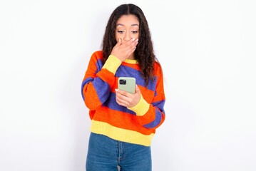 Model being deeply surprised, stares at smartphone display, reads shocking news on website, Omg,...