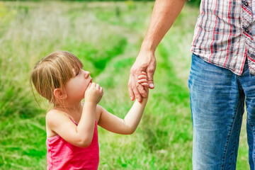 A Hands of happy child and parent on nature in the park family concept