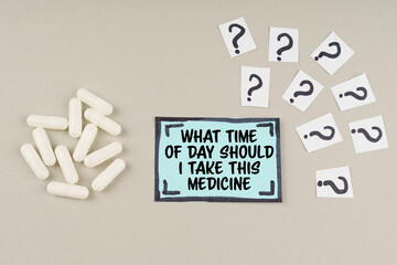 On the table are question marks and a sticker with the inscription - What time of day should i take this medicine