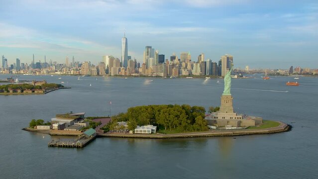 Aerial view of the Statue of Liberty with Manhattan and New Jersey Skyline in the Background. Liberty Island New York City, United States. High Quality Footage Shot from Helicopter.