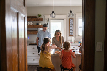 Marine veteran at home with family eating and fixing breakfast. - obrazy, fototapety, plakaty