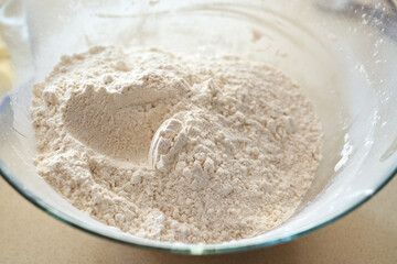 White wheat flour in a bowl - ingredient for baking