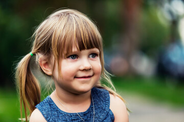 Portrait of a cute young girl with blond hair in pigtails; Edmonton, Alberta, Canada