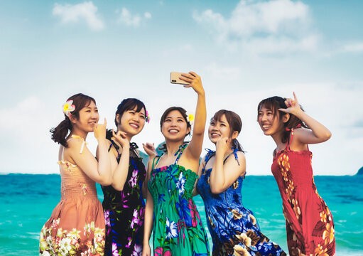 A group of Japanese students taking a self-portrait while on vacation at Lanakai Beach: Oahu, Hawaii, United States of America