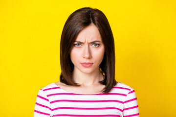 Fototapeta premium Closeup photo of young funny attractive girl looking you gloomy bad mood isolated on yellow color background