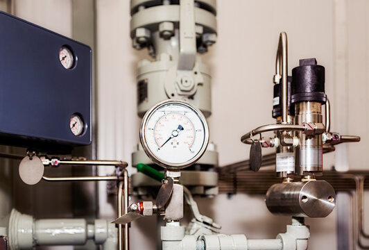Close up of gauge and components of instrumentation and controls assembled in a fabrication plant; Innisfail, Alberta, Canada