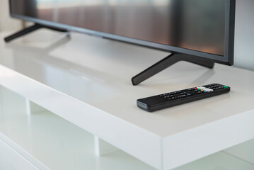 Remote control on the coffee table next to the TV