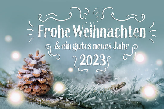 Christmas greeting card 2022 2023 - German language - Merry Christmas and Happy New Year - Xmas Congratulations Card - Fir branch in snow landscape with magic lights
