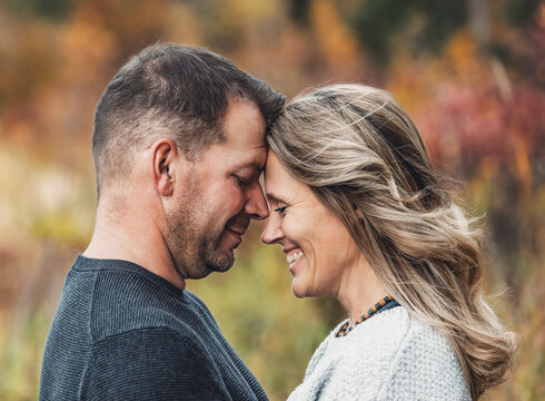A married couple spending quality time together outdoors in a city park during a warm fall afternoon; St. Albert, Alberta, Canada