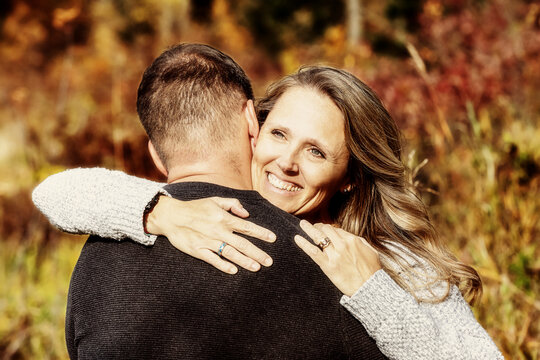 A married couple spending quality time together outdoors in a city park during a warm fall afternoon; St. Albert, Alberta, Canada