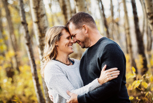 A portrait of a mature married couple outdoors in a city park in autumn; St. Albert, Alberta, Canada