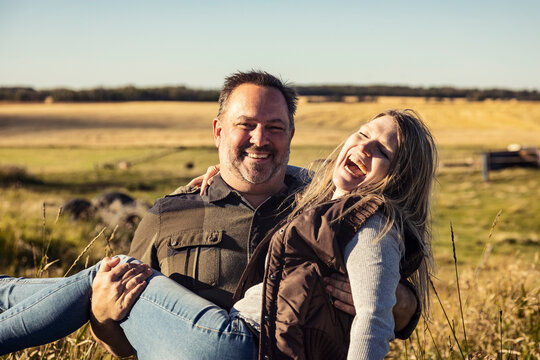 Portrait of a mature couple having fun on their farm; Alcomdale, Alberta, Canada