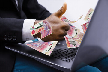 Mauritian rupee notes coming out of laptop with Business man giving thumbs up, Financial concept. Make money on the Internet, working with a laptop