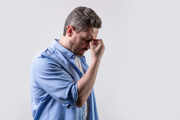 mature man with headache and migraine in studio with copy space. photo of man with migraine