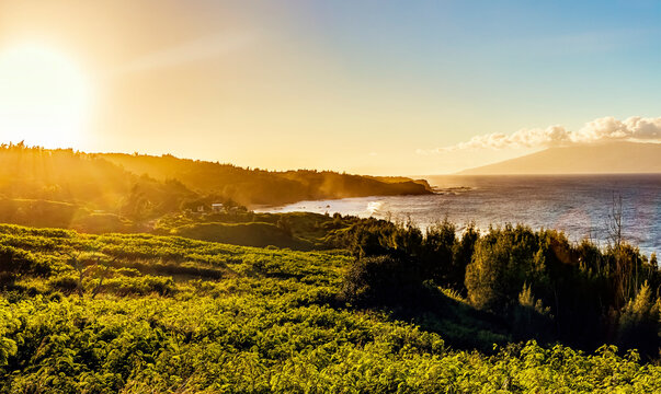 Overlooking the rugged coastline of North West Maui at sunset with the Island of Lanai in the distance;  Maui, Hawaii, United States of America