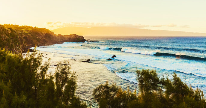 Overlooking the rugged coastline of North West Maui at sunset with the Island of Lanai in the distance; Maui, Hawaii, United States of America