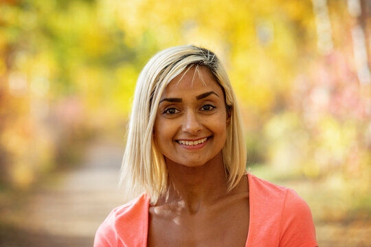 Head and shoulders portrait of a woman outdoors in a park in autumn; Edmonton, Alberta, Canada